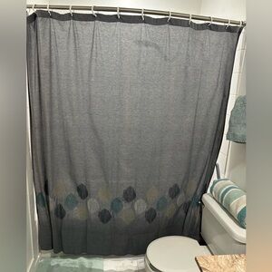 Denim blue shower curtain with colored accents. ￼
has never touched water